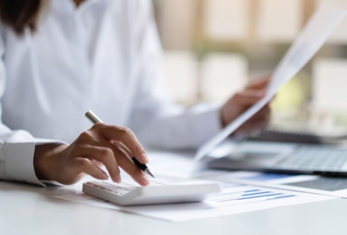 close-up-business-woman-using-calculator-laptop-math-finance-wooden-desk-office-business-working-background-tax-accounting-statistics-analytic-research-conceptxa-1 (1)