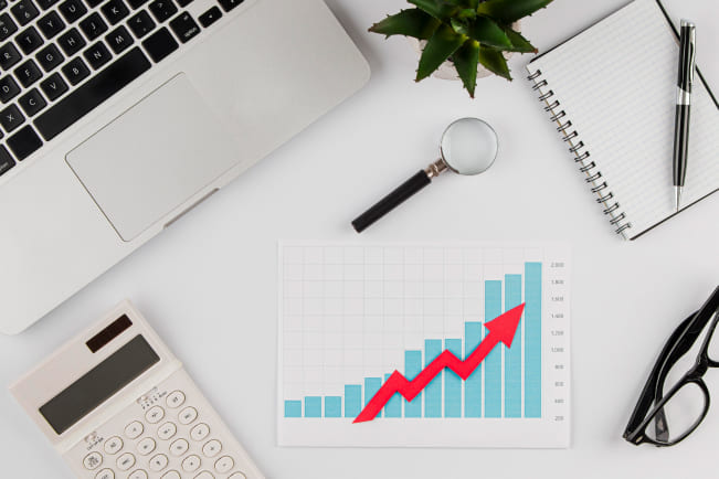 top-view-office-desk-with-growth-chart-laptop-1 (1)